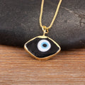 Close-up of the Black necklace option, with a white and blue eye center and gold tone pendant border and chain.