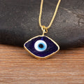 Close-up of the Dark Blue necklace option, with a white and light blue eye center and gold tone pendant border and chain.