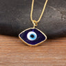 Close-up of the Dark Blue necklace option, with a white and light blue eye center and gold tone pendant border and chain.