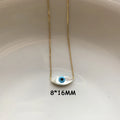 White marquise evil eye pendant on a gold tone chain, shown with an 8 × 16 mm annotation.