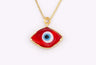 Red eye-shaped pendant with a blue and white center and gold tone border and chain against a white background.