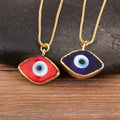 Red and dark blue eye-shaped necklace pendants with blue and white centers, gold tone borders and chains.