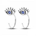 Front view of silver tone open hoop earrings with blue eye centers and upper lash details