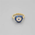 Gold tone ring with a rounded triangular blue eye face, clear accents and black dots