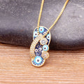Gold tone slipper pendant necklace with blue and white eye motifs, a curved strap and three round side details