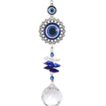 Round blue evil eye suncatcher with a silver tone ring border, stacked blue accents and a clear faceted ball on white