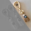 Tan evil eye tassel with a white wrap and pale beaded loop, highlighted as Style C