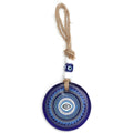 Blue evil eye wall hanging with a horizontal eye inside concentric patterned rings and a beaded rope loop