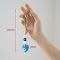 Blue heart evil eye hanging held by its tan rope loop, with red arrows labeled 20 cm and 4 cm