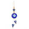 Round blue evil eye hanging with a blue heart above and two blue heart drops on uneven tan cords