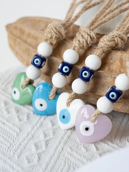 Green, blue, white and pink heart evil eye hangings with tan rope and blue and white beads