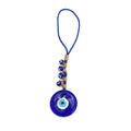 Round blue evil eye pendant on blue cord with tan wraps and four small eye beads along one side