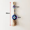 Tassel evil eye wall hanging with image annotations reading 26 cm overall, 3 cm at the upper eye and 4 cm at the lower disc