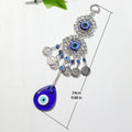 Teardrop evil eye wall hanging laid flat beside a length guide labeled 24 cm and 9.88 in.