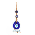 Blue teardrop evil eye hanging with two dark blue upper eyes and four white eye beads below
