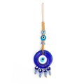 Round blue evil eye hanging with flat and rounded turquoise upper eyes and four blue cube bead drops
