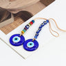 Two round blue evil eye pendants with colorful disc beads and a row of six blue eye beads on tan cord