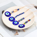Four round blue evil eye hangings with peach oval, six-eye, grey-blue oval and colorful disc bead strands