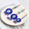 Three blue evil eye hangings with turquoise upper eyes and different cube and faceted bead fringes