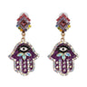 Purple Hamsa earring pair with black-and-white eyes, pale iridescent accents and deep pink centers in diamond-shaped tops.