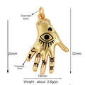 Gold tone hand pendant with black eye, heart and finger motifs, clear wrist accents and measurement annotations