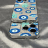 Two overlapping phones in blue eye and turquoise Hamsa cases, showing the bottom port opening and camera cutouts.