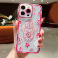 Pink floral Hamsa phone case shown from the back with a patterned palm, scattered flowers and a pink border