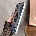 Blue Hamsa and Evil Eye phone case angled to show the side buttons and translucent edge