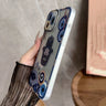 Blue Hamsa and Evil Eye phone case angled to show the side buttons and translucent edge