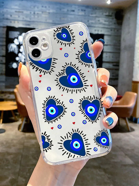 Clear iPhone case with blue heart-shaped eyes, black rays and tiny red hearts, shown on a phone held in one hand.