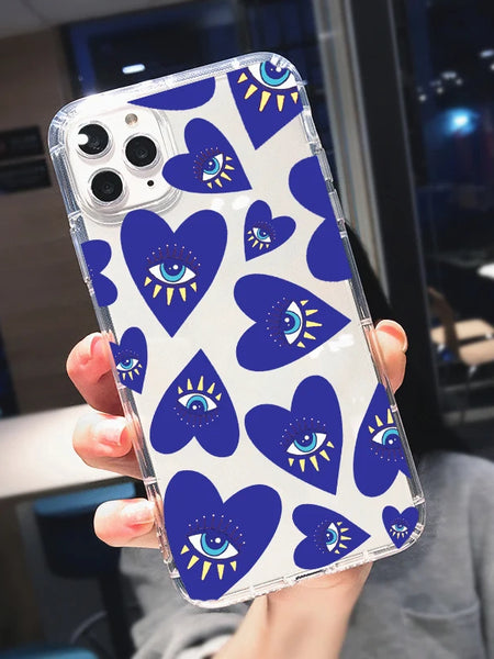 Hand holding an iPhone case with blue hearts, turquoise and white eyes, yellow rays and clear edges