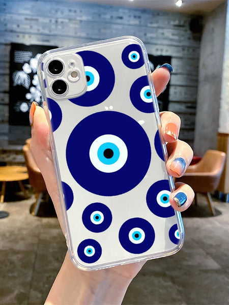 Hand holding a clear iPhone case with a large central blue eye circle and smaller matching circles with white and turquoise rings.