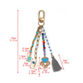 Dimension diagram for the baby charms keychain with multicolored beads, a grey tassel and measurement arrows