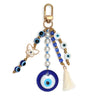 Blue evil eye keychain with a large round eye pendant, white butterfly charm, smaller eye beads and cream tassel