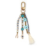 Keychain with LUCKY letter beads, turquoise eye beads, a treble clef, wishbone charm and cream tassel