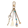 Evil eye keychain with MAMA letter beads, a cream tassel, hamsa hand charm and gold tone clip