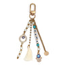 Evil eye keychain with MAMA letter beads, a cream tassel, hamsa hand charm and gold tone clip