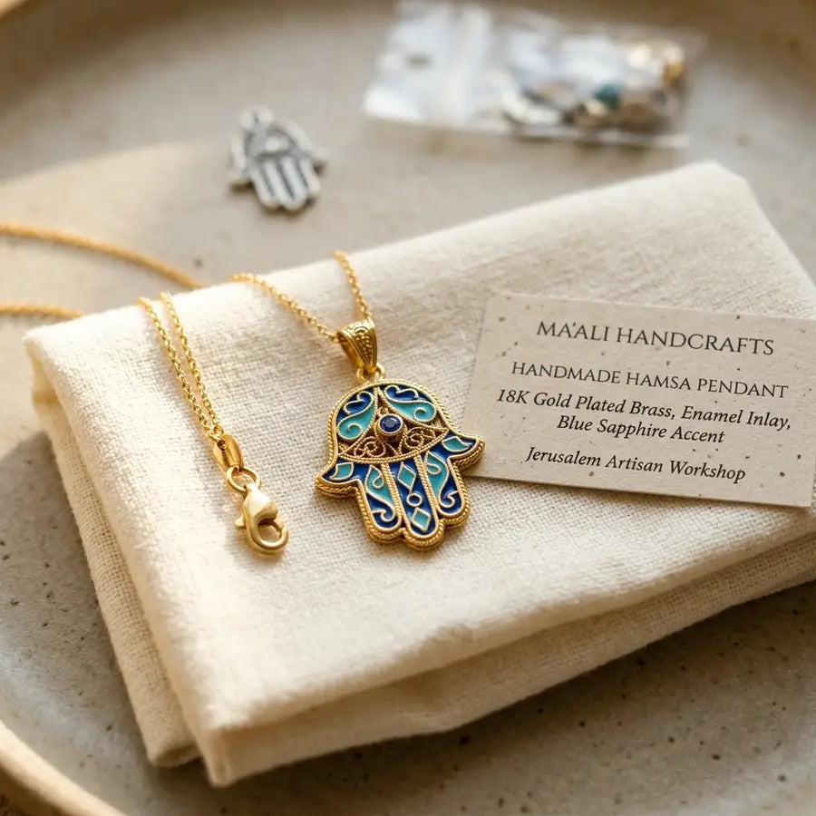 Sharp foreground Hamsa pendant with a material card and clasp detail, with a blurred generic charm package behind it.