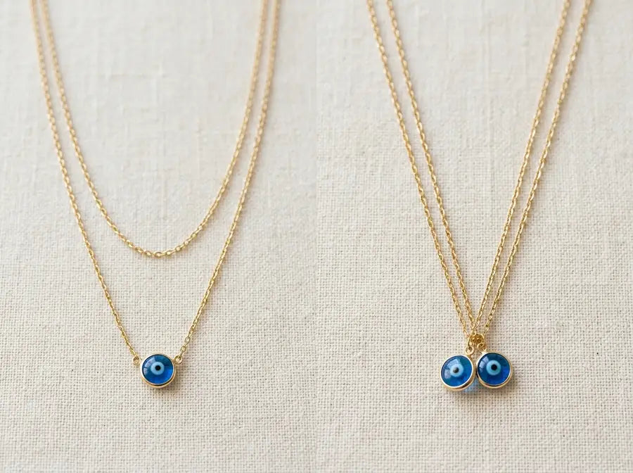 Left side staggered stack with one lead eye pendant beside right side same-length chains with two overlapping equal charms