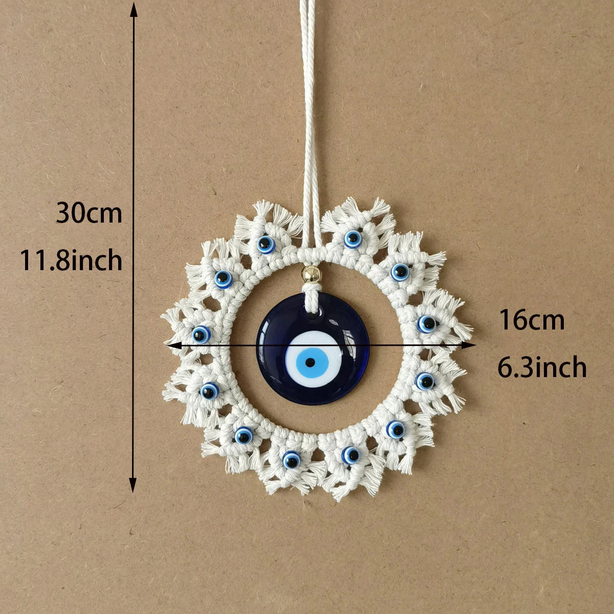 Blue and off-white evil eye wall hanging with dimension arrows labeled 30 cm (11.8 inches) vertically and 16 cm (6.3 inches) across.