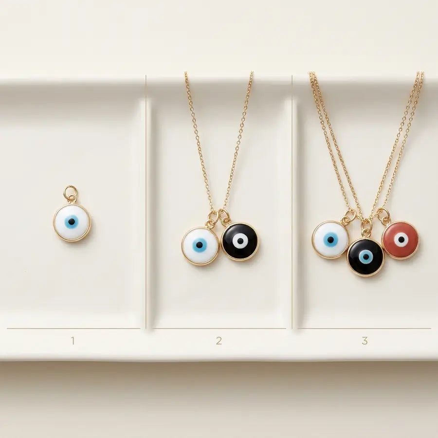 Three-stage layout showing a white evil eye charm alone, paired with black, then layered with black and muted red