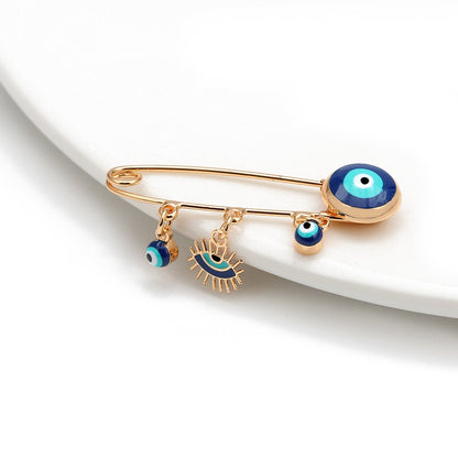 Ward off Bad Luck with our Turkish Evil Eye Brooch Pin with Flower Crown, Hamsa Hand, and Star Charms