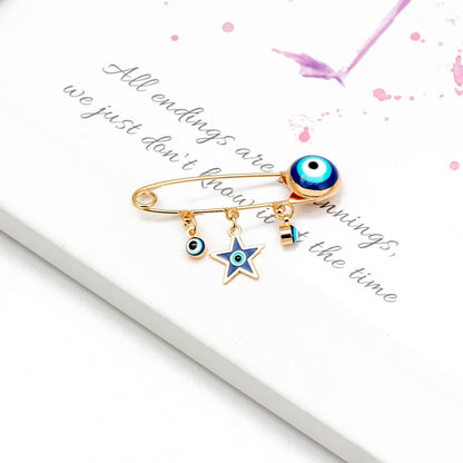 Ward off Bad Luck with our Turkish Evil Eye Brooch Pin with Flower Crown, Hamsa Hand, and Star Charms