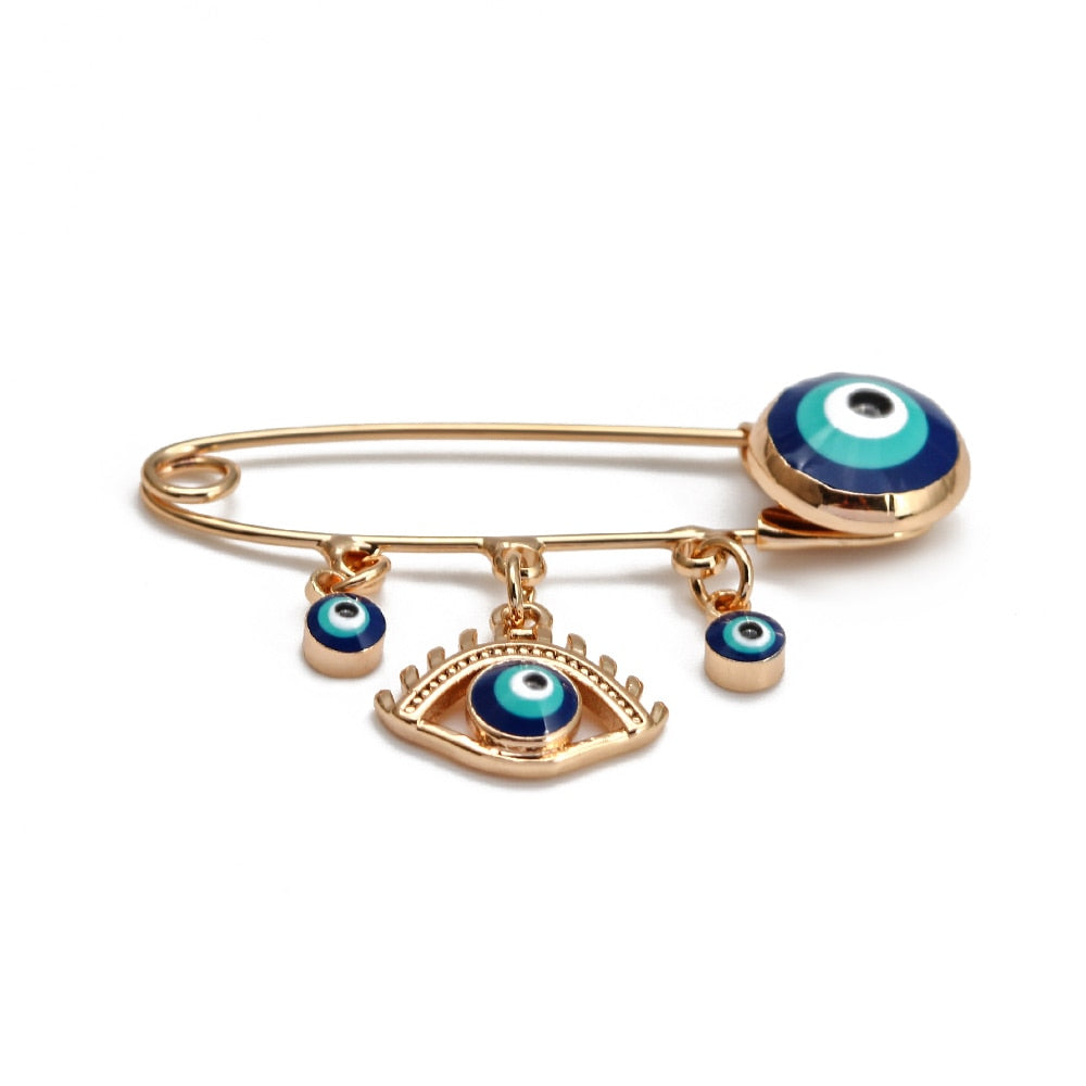Ward off Bad Luck with our Turkish Evil Eye Brooch Pin with Flower Crown, Hamsa Hand, and Star Charms
