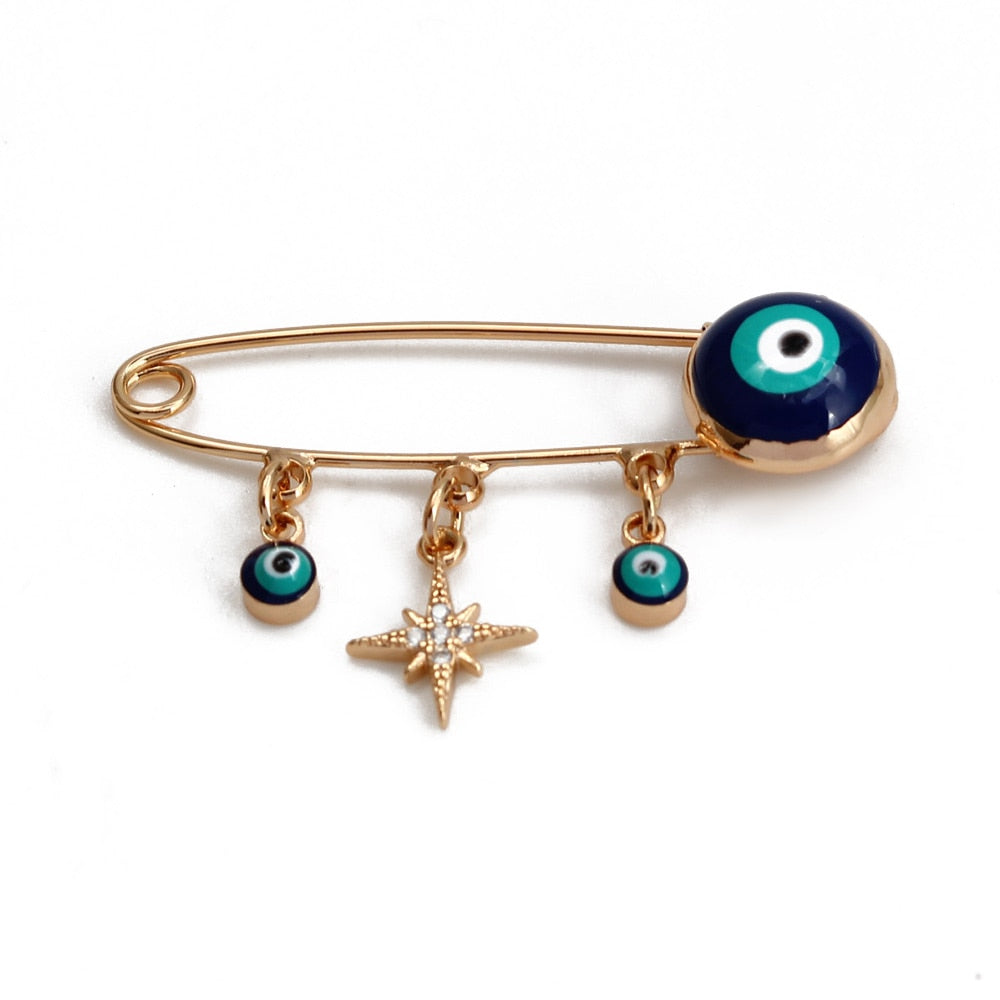 Ward off Bad Luck with our Turkish Evil Eye Brooch Pin with Flower Crown, Hamsa Hand, and Star Charms