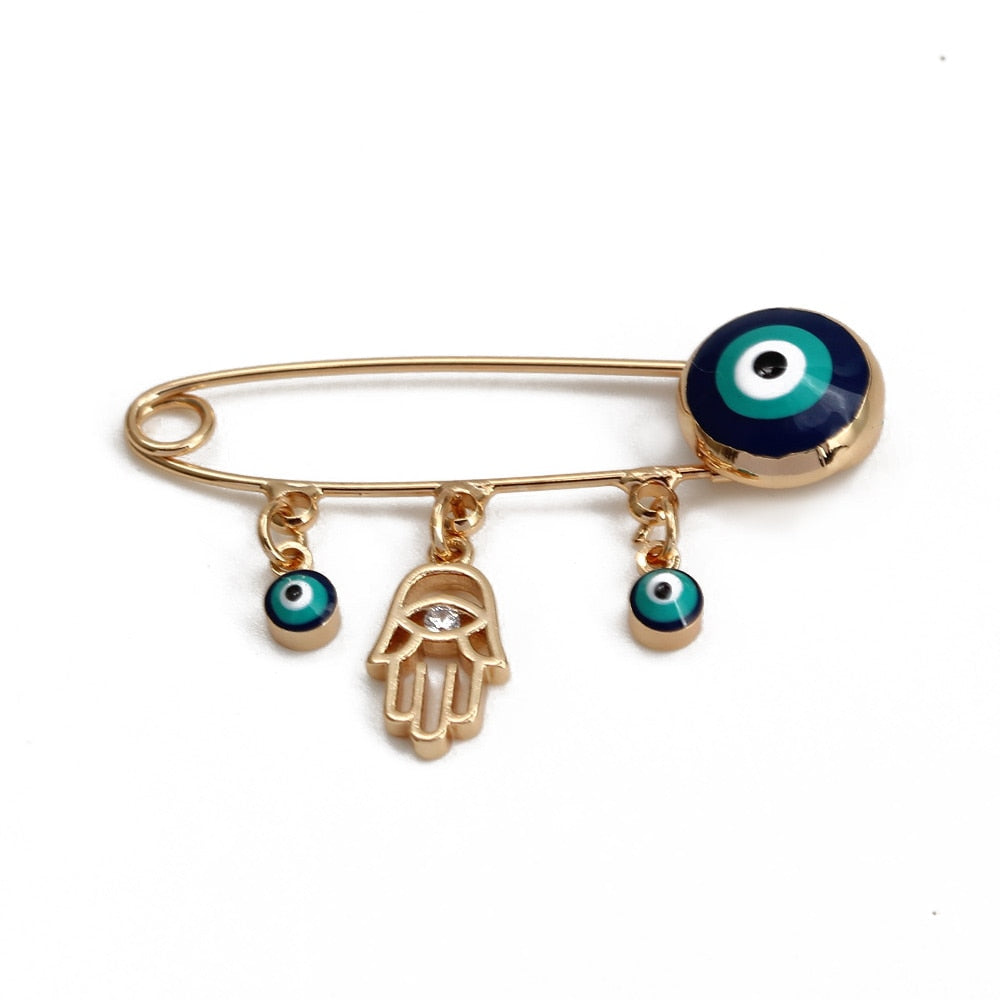 Ward off Bad Luck with our Turkish Evil Eye Brooch Pin with Flower Crown, Hamsa Hand, and Star Charms