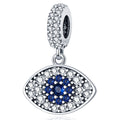 Silver tone almond eye dangle with a blue center, rows of clear accents and a decorated bail