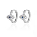 Silver tone evil eye hoop earrings with blue centers and clear accents